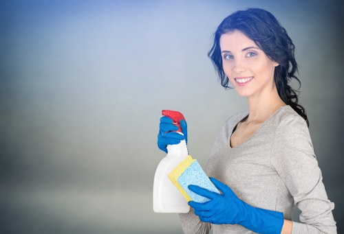 Trained cleaner using specialist carpet cleaning equipment with care
